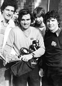 Hibernian footballer George Best signs autographs for fans as Peter Cormack looks on