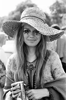 Hippie lady with large hat and eye make up at the free Rolling Stones concert in Hyde
