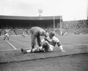 Hirst of Wakefield Trinity seen here gets treatment for a injury leg during the Rugby