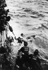 Survivor Prints: HMCS Swanseas seaboat alongside as U-boat survivors are helped out of the sea