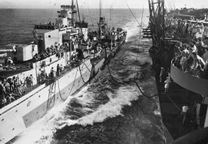 01445 Prints: HMS Illustrious oils a destroyer in the Indian Ocean with the Eastern Fleet 20th May 1944