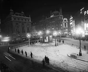 Hoardings surround statue of Eros in London as snow storms cancel new years eve