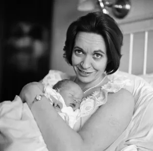 Holding her 12-hour old baby is stage and TV actress Lillias Walker