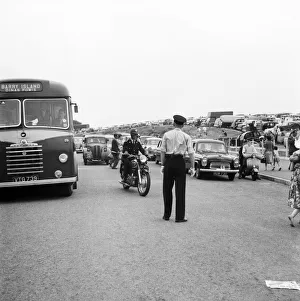 Holiday Crowds at Barry Island: Two Barry policeman control the dangerous crossing point