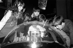 00031 Prints: Holiday makers looking at the moon rock from Apollo IIs moon landing