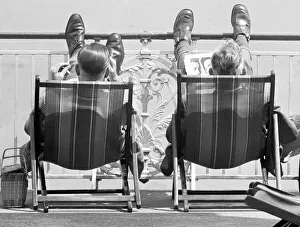 East Sussex Prints: Holiday scenes at Brighton Two holidaymakers put their feet up on Brighton