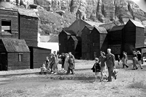 00012 Prints: Holiday scenes. in and around Hastings Tourist walk along the seafront past the wooden