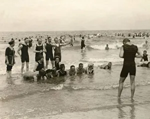 1911 Prints: Holidaymaker taking a photograph of his friends bathing in the sea at Norderney