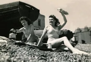 Holidaymakers boil a kettle to make a cup a tea on the pebble beach June 1945