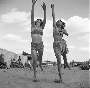 00964 Prints: Holidaymakers playing with a quoit on the beach close to the Britannia Pier