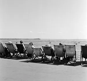 Southend Prints: Holidaymakers relax in their deckchairs for a spot of sunbathing on the beach at Southend