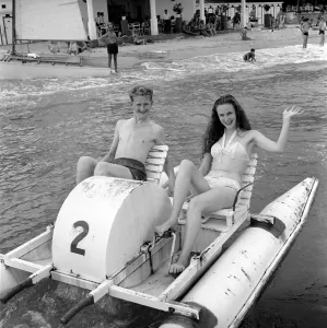 Holidays: Couple riding on a pedalo off the coast of Corsica. August 1957