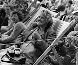 00036 Prints: Holidays: This elderly holidaymaker enjoys the Mirror Beach Fashion Show at Yarmouth