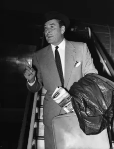 Leather Coat Prints: Hollywood star Errol Flynn seen here arriving at London Airport 17th November 1953
