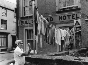 Powys Prints: Hotel Landlady Mrs Maureen Roach puts up another line of washing outside the Bull