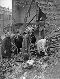 Homeless Collection: Householders search through the remains of their bombed home, searching for belongings