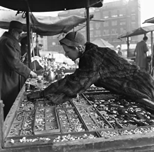 Housewife browsing the antique stalls of the New Caledonian Street Market for jewellery