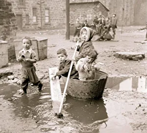 Housing slums in the Gorbals district of Glasgow where children use any materials to hand