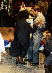 HRH Prince Charles dances with a member of the crowd during 40th birthday celebrations