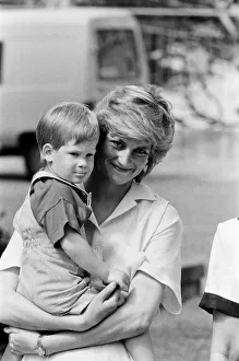HRH Princess Diana, The Princess of Wales holds her young son Prince Harry on holiday in