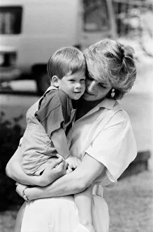 01063 Prints: HRH Princess Diana, The Princess of Wales holds her young son Prince Harry on holiday in