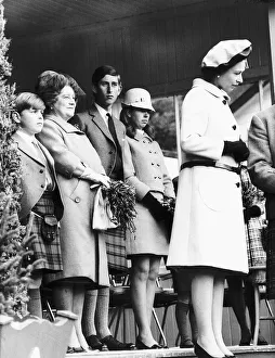 HRH Queen Elizabeth II standing with her children Prince Charles