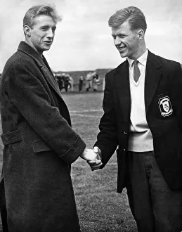 Huddersfield Town footballer Denis Law shaking hands with fellow Scottish footballer John