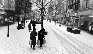 Huddled up against the winter snow, shoppers in a strangely quiet Church Street during