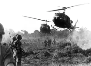 HUEY HELICOPTERS LAND IN FIELD DURING THE VIETNAM WAR TO PICK UP CASUALTIES SUSTAINED BY