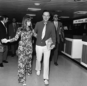 Hugh Hefner pictured with his girlfriend Barbi Benton at the airport. 6th September 1969