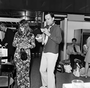Hugh Hefner pictured with his girlfriend Barbi Benton at the airport. 6th September 1969