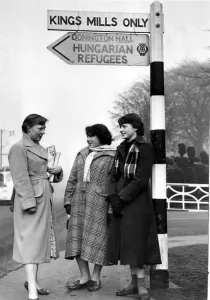 Core80 Prints: Hungarian Refugees Three girl guides stand at the sign post for Hungarian Refugees
