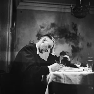 Arms Prints: Hungarian Revolution. An unidentified Hungarian man writing at a table in a restaurant