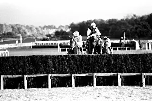 Over the last hurdle safely Narvik (right) is pushed out by Denis Atkins to shrug off