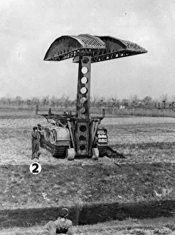 Scissors Prints: Hydraulic arm lifting a Scissors self propelled bridge into position. June 1945