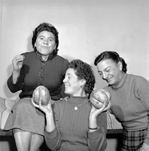 00069 Prints: I ve got a lovely pair of coconuts. Woman holding a coconut. Circa 1963 A736a