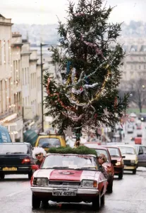 Ian Johnson drives his Ford Capri with a Christmas tree on the roof of the car