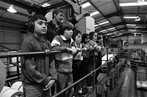 Ian Kenworthy shows the Examiner press centre to children from Stile Common Junior School