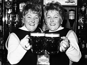 Identical twin barmaids Joan Metcalf and Marie Dunn seen here behind the bar 1977