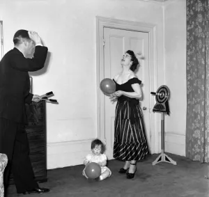 Magician Prints: Illusionist Jon Evans practises his knife throwing with his partner and child