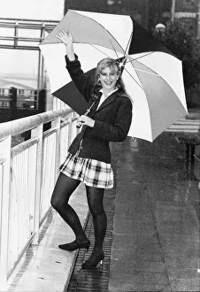 Imogen Stubbs Actress holding up Umbrella in rain and waving