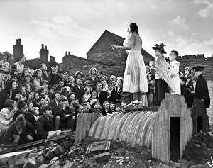 Show Prints: An impromptu Childrens show using a Anderson shelter for a stage during the London