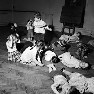 Physical Education Prints: Infant schoolchildren playing during a dance and movement class. Feburary 1953 D715-004