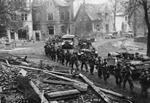 Armies Prints: Infantry, guns and trucks 0f the 15th Scottish Division advance through Kleve
