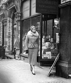 Ingrid Bergman window shopping in Bond Street London wearing a fur trimmed tweed suit