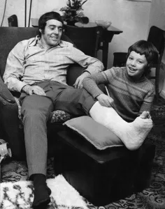 Cast Prints: Injured Liverpool footballer Ian St John still manages a smile despite his broken leg as
