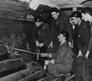 An instructor at the Government pit school showing Bevin Boys how to follow a seam of