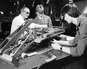 Apprentices Prints: Instructor Jack Laybourn works on a model of an armoured bridgelayer with apprentices