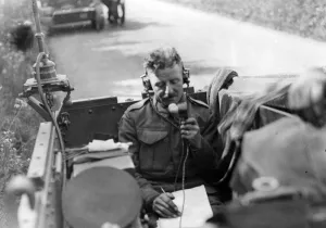 Invasion exercise in and around the Cardiff area. Signaller taking a radio message in an