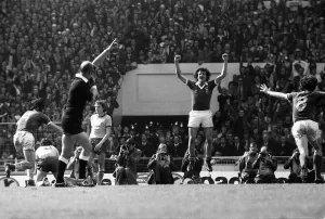 Ipswich players Derek Nippard and Roger Osborne celebrate at the final whistle as they